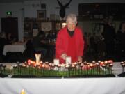 Battle Ground: Event coordinator Kay Beasley of the Battle Ground Elks Lodge lights a candle in memory of deceased Elks members.