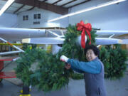 Hudson's Bay: Nana Shin helps the Vancouveria Garden Club make wreaths at the Pearson Restoration and Maintenance hangar at Pearson Air Field in Vancouver.