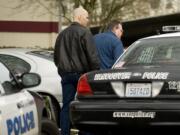 Detectives James Phelps, left, and Barry Folsom with the Clark County Sheriff's Office respond to a call involving a child at the Ashley Terrace Apartments on Monday.