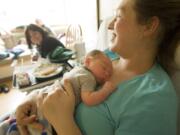 Katherine Thayer holds her newborn son, Noah, in their room at PeaceHealth Southwest Medical Center's Family Birth Center on Wednesday.