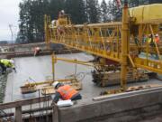 Workers, above and top, put down fresh concrete Thursday that&#039;s part of a new Interstate 205 onramp at Northeast 18th Street in Vancouver. The interchange project could cause some traffic congestion and single-lane closures for weeks starting Monday.