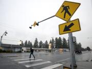 A man runs across Mill Plain Boulevard on Jan. 4 where a pedestrian had been fatally injured by a car on Dec. 29.