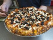 A Pepperoni Plus pizza is served Jan. 7 at Bellagios Pizza in east Vancouver.