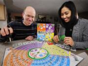 Doug Loriz, left, and Nilda Loriz, owners of Vancouver-based DNA Family Games, spent three years self-promoting Bull's-eye, the board game they invented.