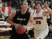 Woodland center Bryce Mulder (0) shoots as Washougal center Josh Bischoff (35) defends.