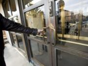 The brass-trimmed front doors at the 1940 Clark County Courthouse could be restored, along with other brass fixtures, with help from a state historic rehabilitation grant.