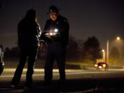 State patrol Trooper Ben Taylor administers a field sobriety test to a driver who nearly crashed her car into a concrete barrier on state Highway 500. Ninety intoxicated drivers were arrested between Aug. 17 and Sept.