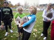 Whiley Middlemas, 9, center, and Oliver Clauson, 9, in green, were among the 20 runners who won a frozen turkey during a raffle at the Clark County Running Club's annual Turkey Trot at Marine Park on Saturday.