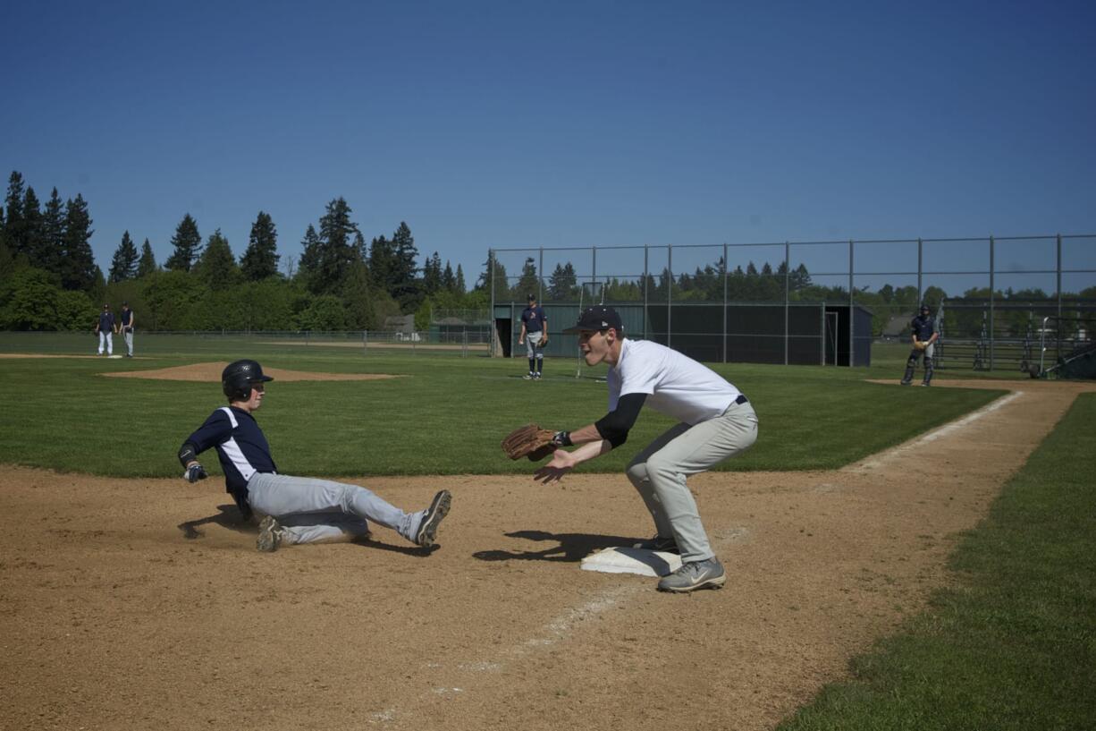 Sophomore James Brooks slides in to third base while fellow sophomore Alec Chaney awaits the throw as Skyview prepares for the school's first appearance in the state baseball tournament.