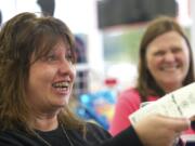 Denise Connolly, left, of Vancouver will go traveling with friend Linda Jacobs, right, if she hits Mega Millions jackpot on  Friday.