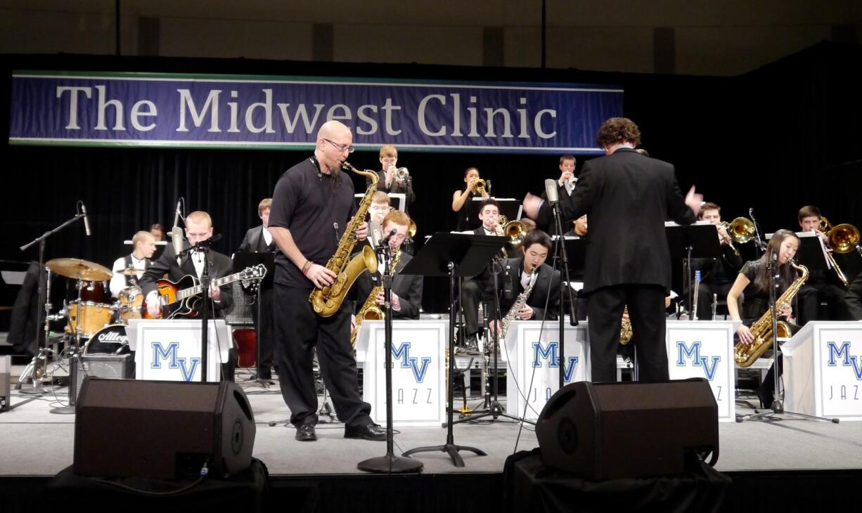 The Mountain View High School Jazz Band were joined by saxophone giant Jeff Coffin, front left, for a few choruses at the Midwest Clinic in Chicago in December.