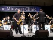 The Mountain View High School Jazz Band were joined by saxophone giant Jeff Coffin, front left, for a few choruses at the Midwest Clinic in Chicago in December.