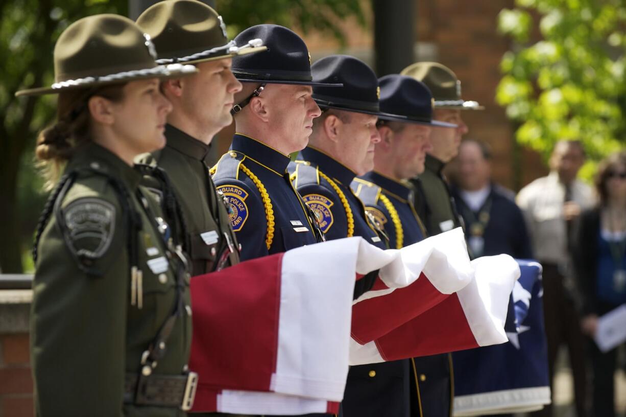 STEVEN LANE/The Columbian
Flag-bearers from a multi-agency honor guard wait to raise the flag to half-staff during the annual Clark County Law Enforcement Memorial Ceremony on Thursday at the Clark County Public Service Center.