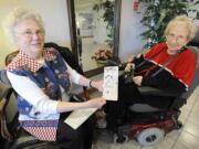 Virginia Jongeward, left, and Doris Olson show the birthday card that has been a symbol of their friendship for 50 years.