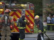 Fire fighters respond to an apartment fire where a man was trapped on the second floor until a neighbor -- himself an off-duty firefighter -- helped him down with a ladder before crews arrived on Monday.