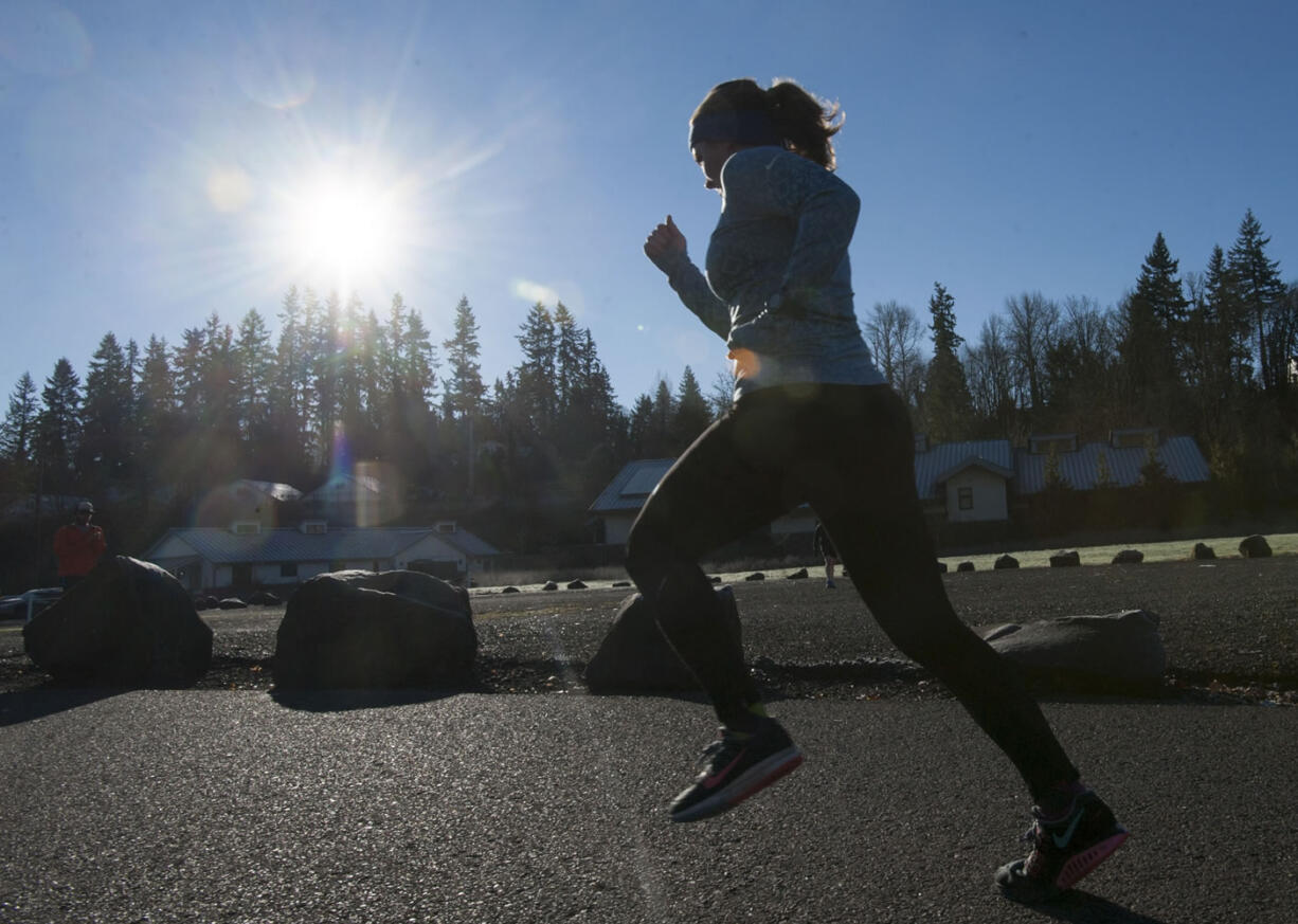 A member of the Clark County Running Club kicks off the new year by running in the club&#039;s annual Hangover Run in Salmon Creek Regional Park on Friday. About 130 runners braved the cold to participate.