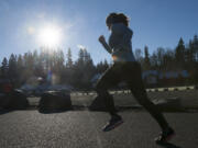 A member of the Clark County Running Club kicks off the new year by running in the club&#039;s annual Hangover Run in Salmon Creek Regional Park on Friday. About 130 runners braved the cold to participate.