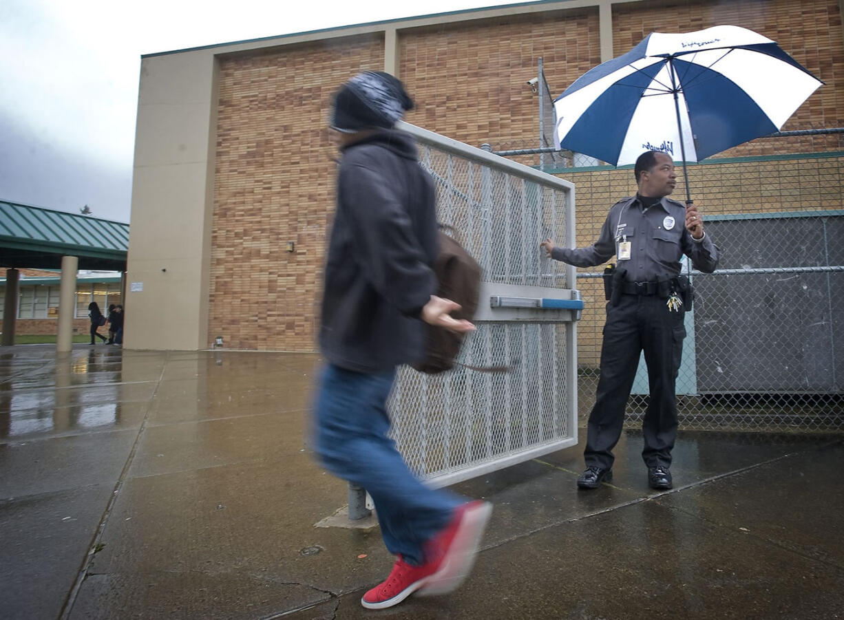 District Resource Officer Donald &quot;Raven&quot; Hubbard gets ready to lock an exterior gate at McLoughlin Middle School.