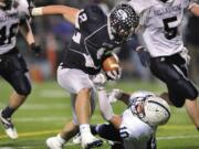 Skyview's Parker Henry runs over Drew Griffin of Bellarmine Prep to pick up a first down during the second half Saturday.