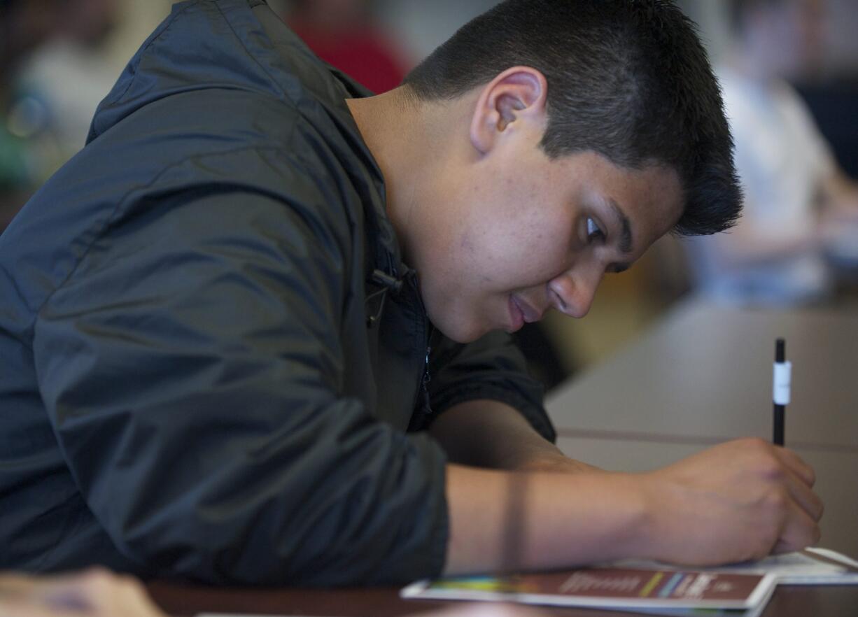 Hudson's Bay High School student Jesus Cortes, 16, takes notes at a seminar Monday at Clark College's annual Career Days.