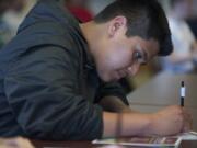 Hudson's Bay High School student Jesus Cortes, 16, takes notes at a seminar Monday at Clark College's annual Career Days.