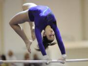 Britni Atwell of Heritage High School scored a 7.175 on the uneven bars at the State Gymnastics competition Friday.