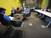 Audience members enjoy lunch during a Lunch Pail Tales session with Jericho Knight, left, a senior library assistant, Wednesday at Vancouver Community Library. The next session will be Feb.