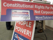 Clark College student Gregory Cunningham, 36, left, speaks to Jeff Stookey, right, a volunteer for MoveToAmend.org, during a forum Wednesday at Washington State University Vancouver on the Supreme Court's Citizen United decision.