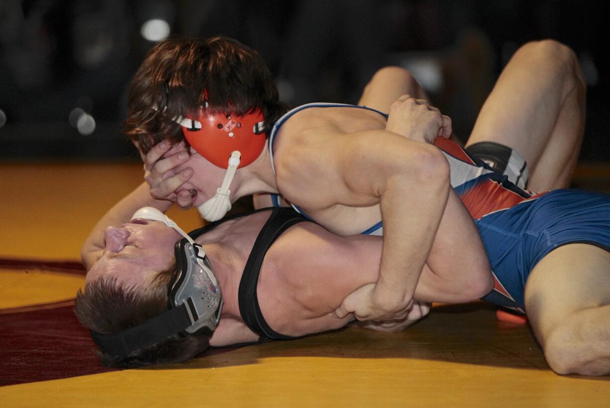 Trevor Newburn (top) of Ridgefield defeats Joseph Harnett of Battle Ground for the 120-pound division title at the Clark County Wrestling Championships at Prairie High School.