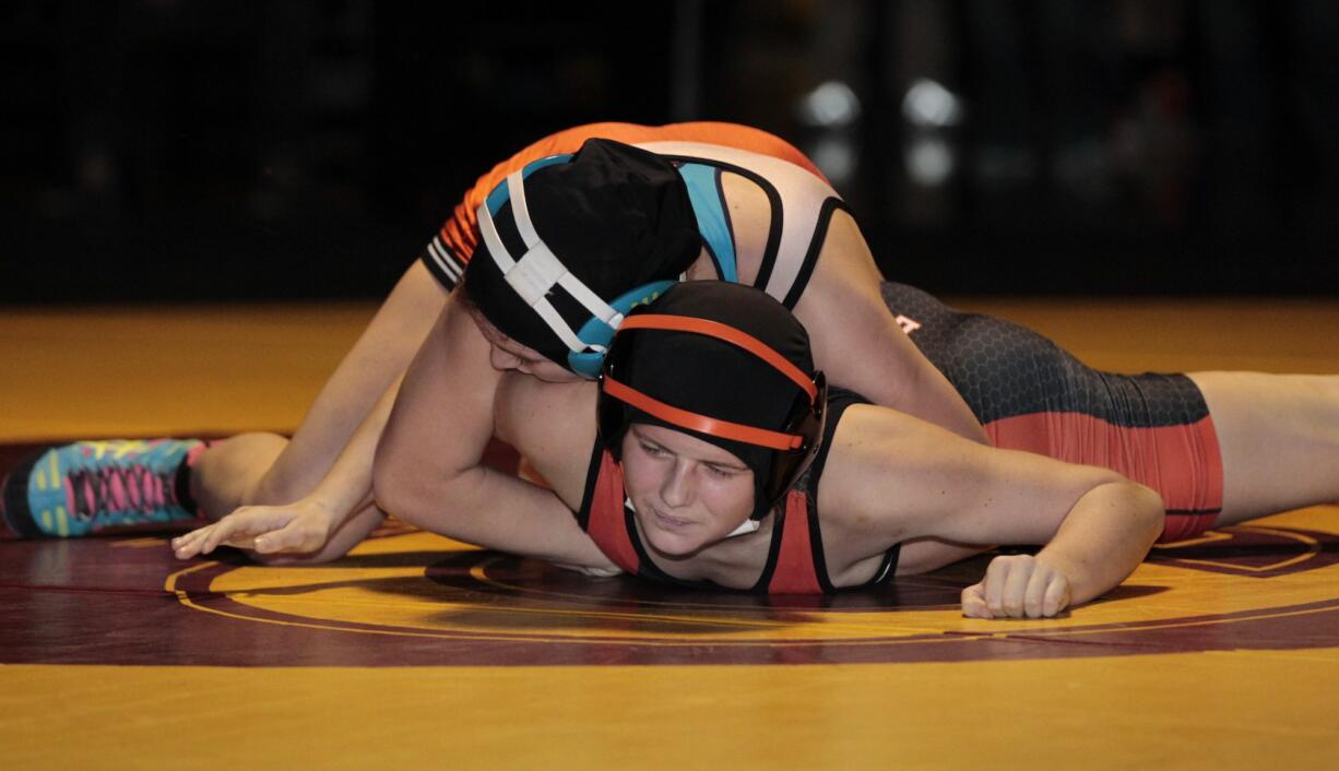 Sierra Joner (top) of Battle Ground beats Signe Zacho of Washougal in the 130-pound final to capture her third Clark County Wrestling Championship.