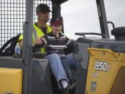 Derek Fechtner, 6, of Woodland takes his turn operating a Deere 850J bulldozer Sunday afternoon.