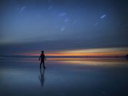 &quot;Midnight Light&quot; by Lijah Hanley came in second place in the National Geographic Student Expedition Contest. It's a dual exposure self-portrait. He shot one 10-minute exposure of the beach and a second 30-second exposure of himself for the image.