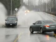 Motorists on Fruit Valley Road encounter high water Thursday in Vancouver.