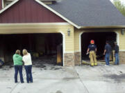 A garage fire did about $30,000 damage to this Ridgefield-area house on Sunday but a sprinkler system kept it from causing much more damage, said Battalion Chief Tim Dawdy of Clark County Fire &amp; Rescue.