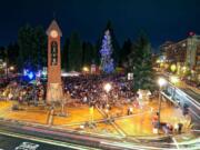 Revelers gather in Esther Short Park early Friday evening after the annual lighting of the park's Christmas tree.