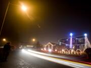 Neighbors of Brandon Whitehead in the Orchards area enjoy his elaborate Christmas light display each year and take the accompanying music and traffic in stride.