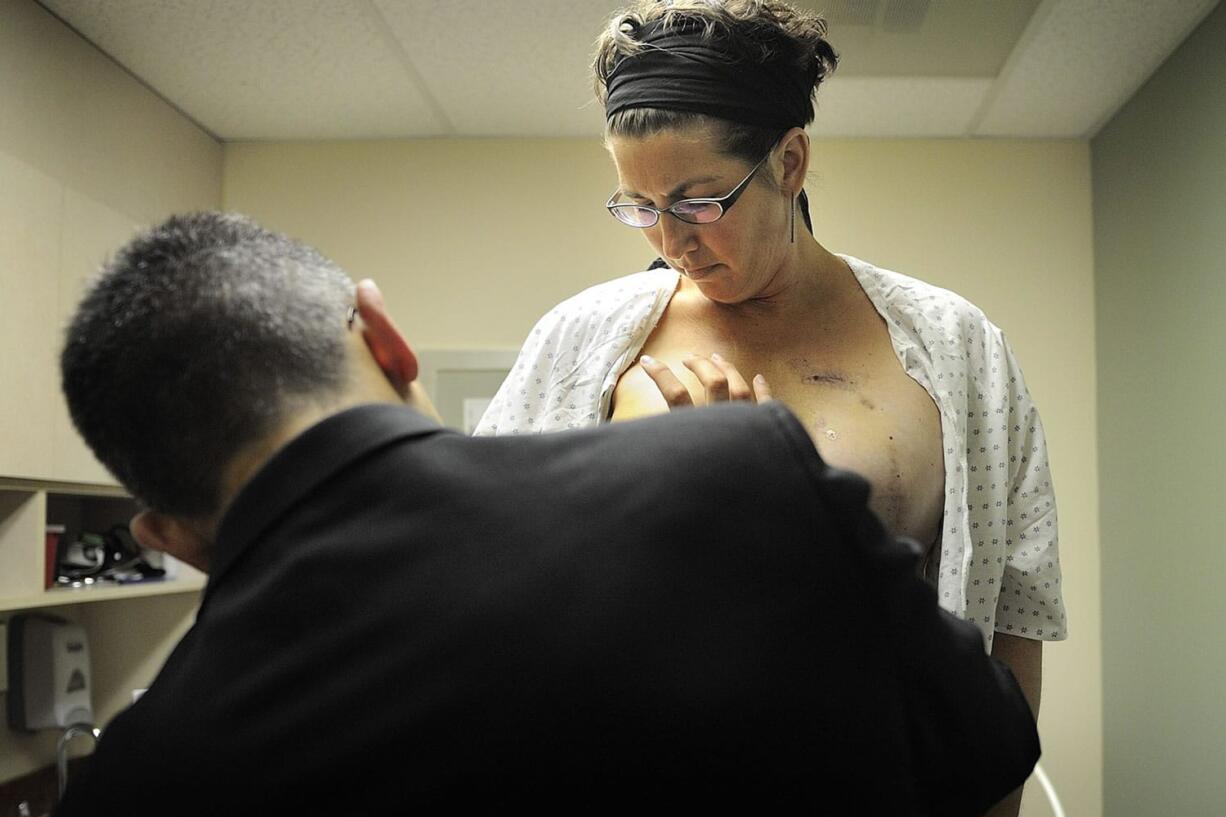 Dr. Allen Gabriel examines Krista Colvin on Nov. 4 in Vancouver as part of a follow-up after Colvin underwent reconstructive surgery 10 days before.