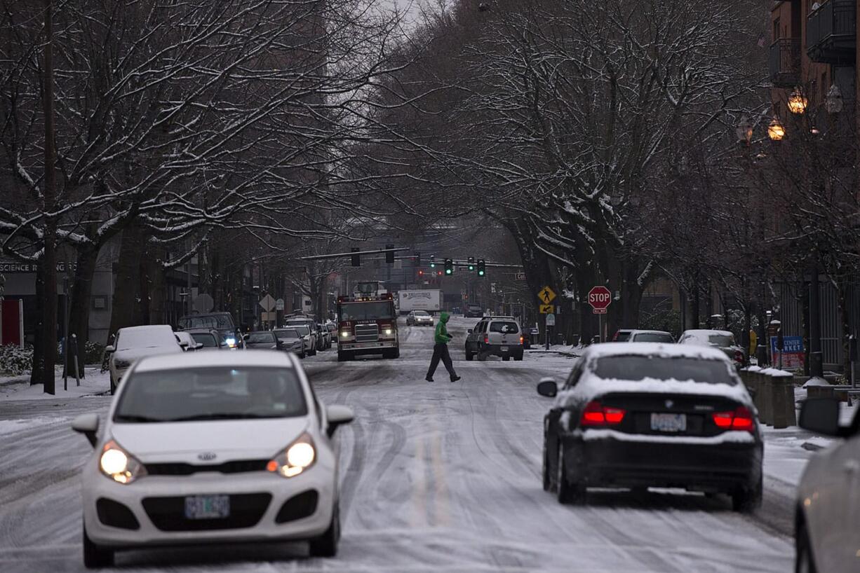 Motorists and pedestrians alike dealt with icy downtown roads, such as West Eighth Street in downtown Vancouver, on Monday morning. Roads could be icy in some spots Tuesday morning, forecasters say, but temperatures will warm later in the day.