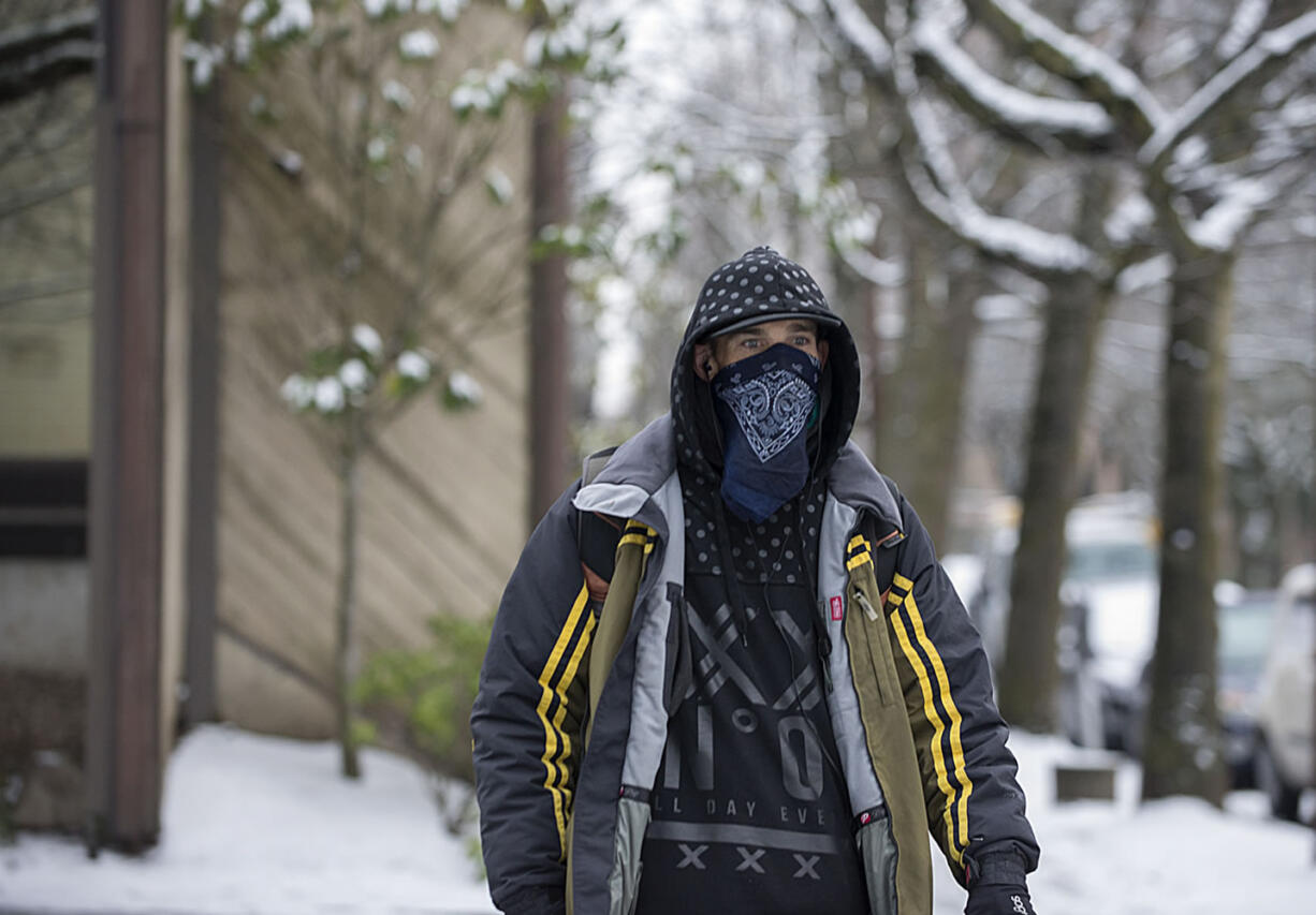 Brian McKenzie of Vancouver tries to stay warm in the cold weather Monday morning.