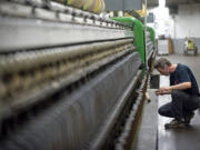 General helper Jeff Hamilton works inside the spinning house at the Pendleton Woolen Mill in Washougal.