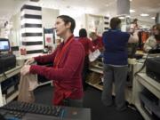 J.C. Penney sales associate Melissa Glogosh, 41, rings up a customer at Westfield Vancouver mall on Dec. 9.