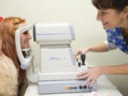 Roxy Vanni of Portland has her eyes checked Thursday by Robin Brugh of Evergreen Eye Care at Project Homeless Connect.