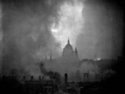 The iconic dome of St. Paul's Cathedral is silhouetted against the flame-lit sky after a 1941 German bombing raid against London.