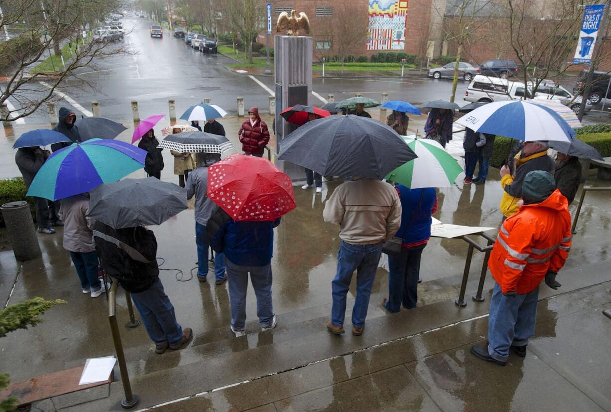 People rally in Vancouver against a state rule on restrooms.