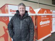 Michael Piper, executive director of The Arc of Southwest Washington, shows off the nonprofit&#039;s new donation collection bins. The donations benefit programs at The Arc, which support people with intellectual and developmental disabilities.