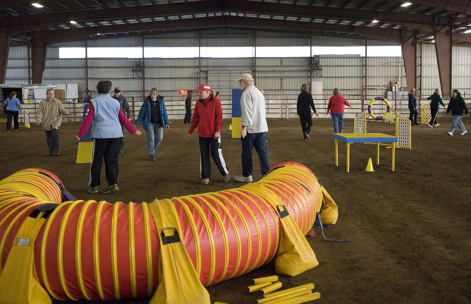 Handlers walk the course before competition at the 8th annual American Kennel Club sanctioned all-breed agility trial at the Clark County Event Center on Saturday February 4, 2012. The three day event has 277 dogs competing that are mostly from Washington and Oregon.