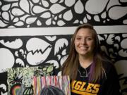 Dusti Blair, a Hudson's Bay softball player, Weber State signee and Vancouver School of Arts and Academics student, poses with her art work in front of a mural that she painted inside her bedroom.