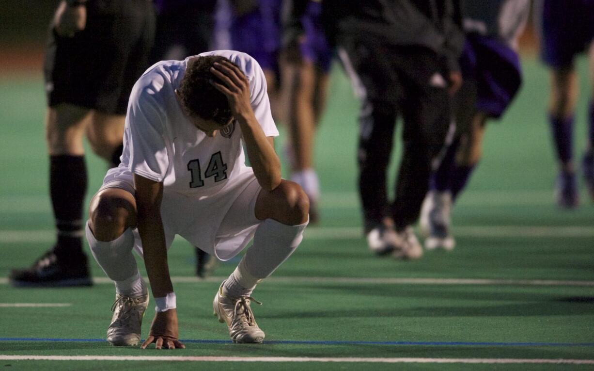 Union's Davis Strawn reacts after missing a shootout attempt as Issaquah beats the Titans in the state playoffs.