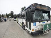 Passengers wait to board a C-Tran bus April 20 at the Vancouver Mall Transit Center.