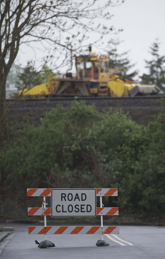 BNSF contractors work on the track at the south end of Esther Street on Friday May 4, 2012.